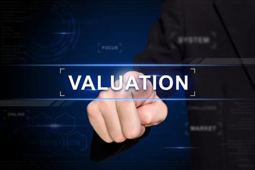business hand clicking valuation button on virtual screen