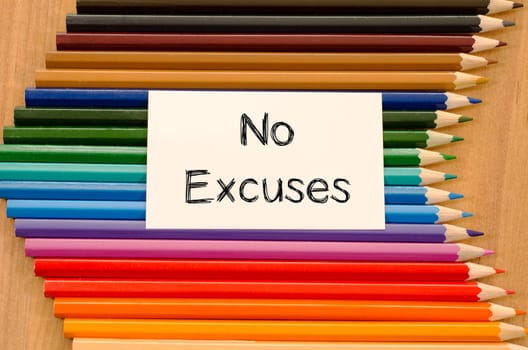 Blank white paper and colored pencil on wooden background