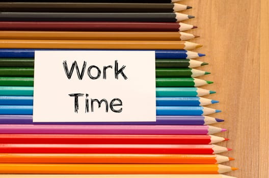 Blank white paper and colored pencil on wooden background