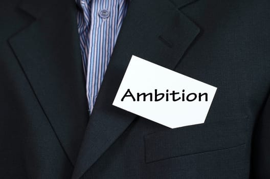 Ambition text note concept over business man background.