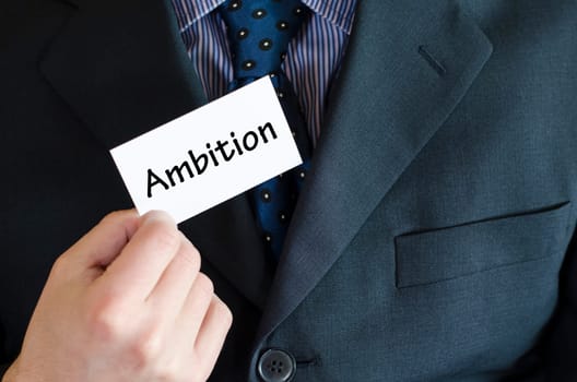 Ambition text note concept over business man background.