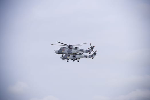LEEUWARDEN, NETHERLANDS - JUNE 6, 2016: Two Royal Navy AgustaWestland AW159 Wildcat helicopters in action during the Royal Dutch Air Force days