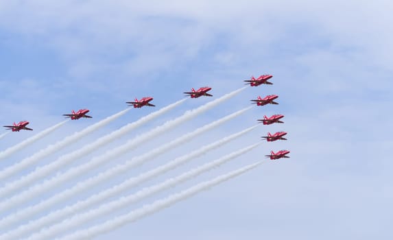 LEEUWARDEN, NETHERLANDS - JUNE 6, 2016: Famous RAF Red Arrows performing at the Dutch Air Force Open days.