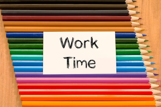 Blank white paper and colored pencil on wooden background
