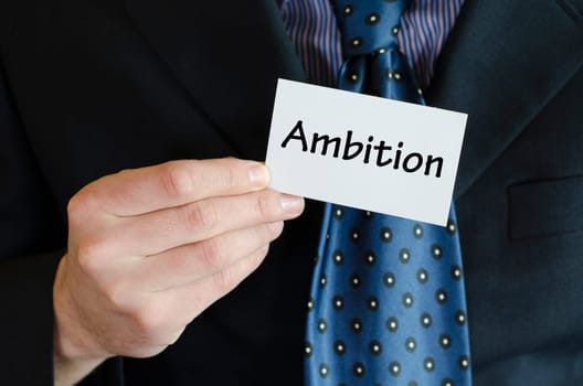 Ambition text note concept over business man background.