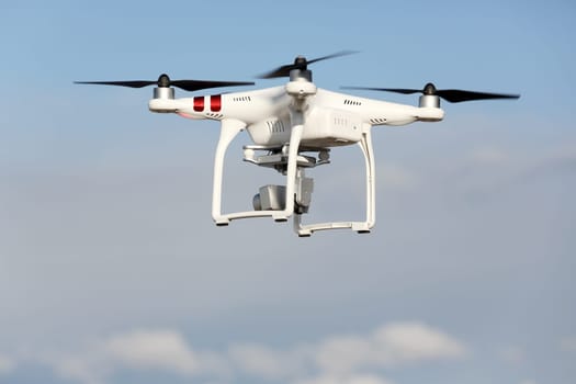 Drone quad copter with flying in the blue sky