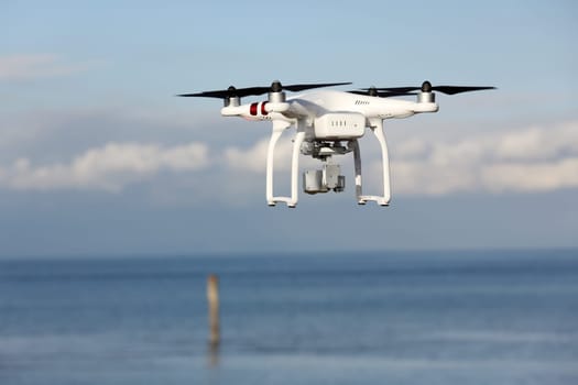 Drone quad copter with flying in the blue sky