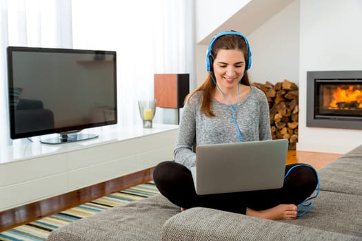 Beautiful woman at home and listen music