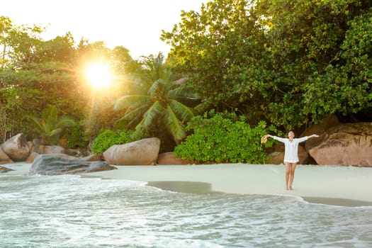 Beautiful woman enjoying the beautiful beachs of Praslin, Seychelles