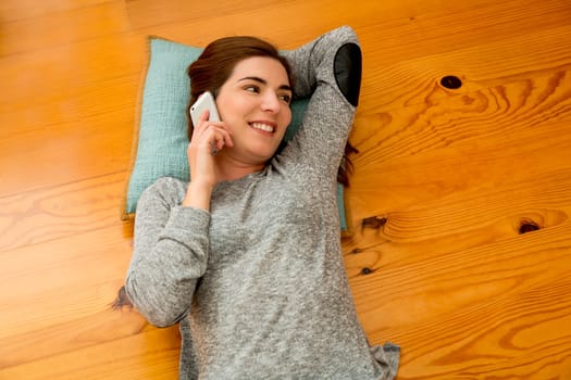 Beautiful woman at home sending text messages