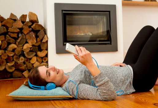 Beautiful woman at home sending text messages