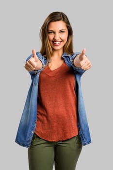 Beautiful and happy woman with thumbs up