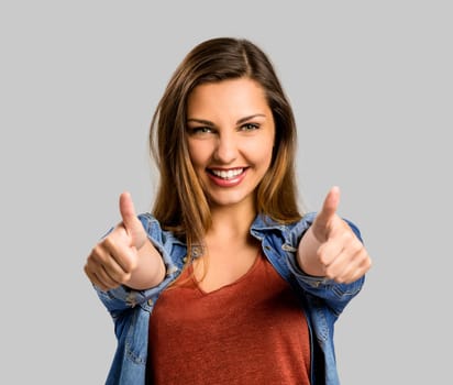 Beautiful and happy woman with thumbs up