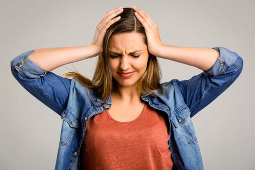Beautiful woman with hands on head worried with something