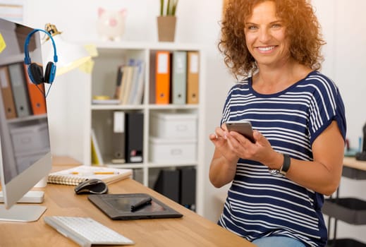 Middle aged woman at office making a phone call