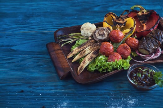 Grilled vegetable on a blue wooden background