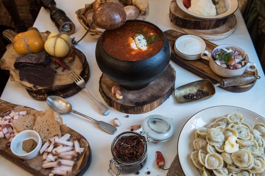 Russian food: borsch pickles cheese meat dumplings and fat