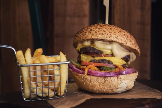 Tasty classical burger with fried potato