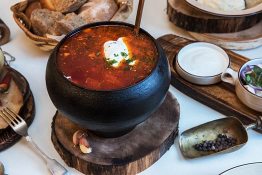 Russian borsch at pot on the table