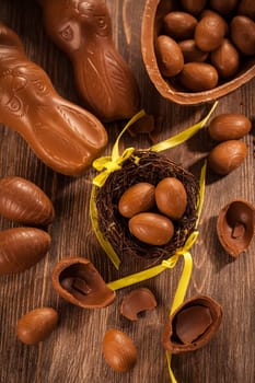 Assorted chocolate eggs for Easter on wooden background