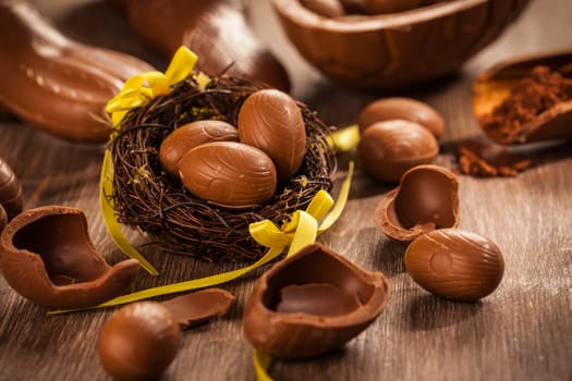 Assorted chocolate eggs for Easter on wooden background
