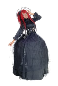 A young beautiful African American woman standing in a long black.Victorian dress and red hair, isolated for white background..