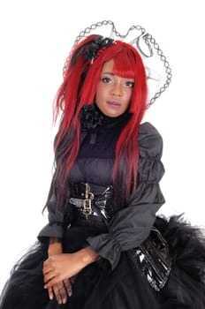 A beautiful African American woman with long red hair and a lace crown.sitting in a black Victorian dress, isolated for white background..