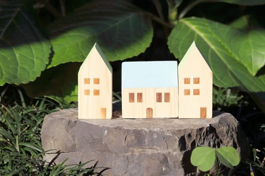 Miniature model of house on stone in the garden