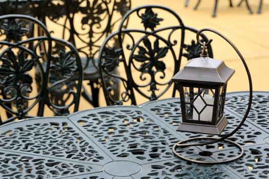 vintage lantern with chairs and table