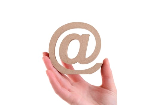 Hand holding wooden email symbol isolated on white background