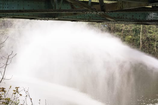 Fire brigade sprays extinguishing water from fire hoses during an exercise...