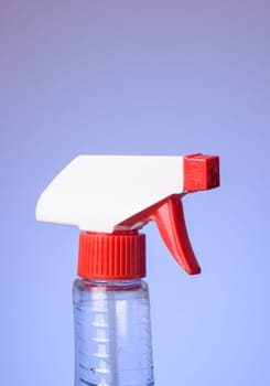 Top of squeeze spray bottle isolated on bluish background