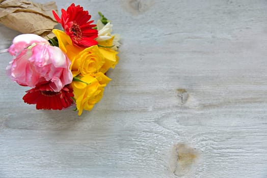 colourful bouquet of flowers on an old wooden background