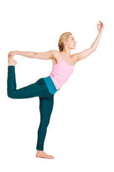 Lateral full-body view of a young woman during yoga exercise "the dancer"" (Natarajasana) against a white background with a slight shadow."