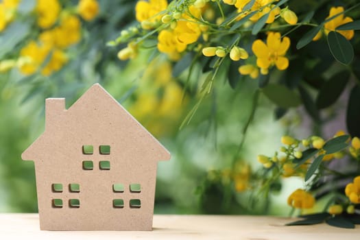 Miniature model of house with beautiful blossom tree
