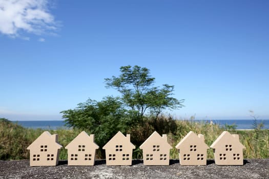 Miniature model of house with blue sky background