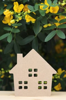 Miniature model of house with beautiful blossom tree