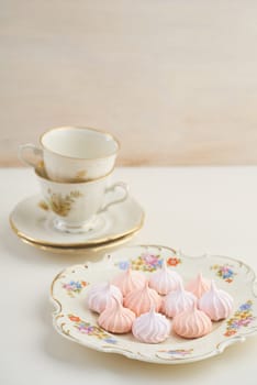 Tea time with pastels colored meringue kisses confectionary