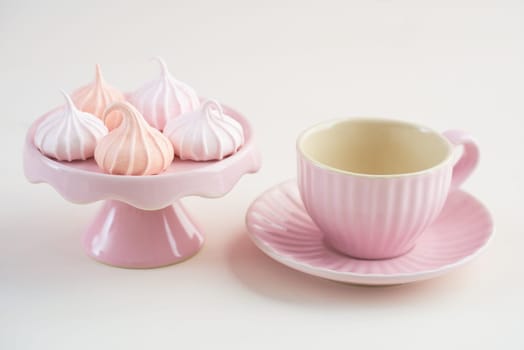 Tea time with pastels colored meringue kisses confectionary