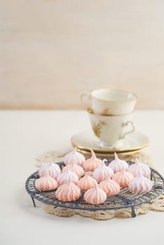 Tea time with pastels colored meringue kisses confectionary