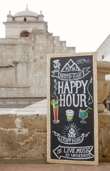 AREQUIPA, PERU - JANUARY 07, 2017: Happy hour board with text written in chalk Arequipa, Peru.