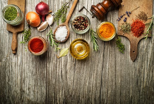 Fresh herbs and spices on a wooden background
