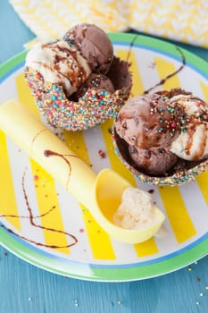 Ice cream in small bowls of chocolate and sugar sprinkles
