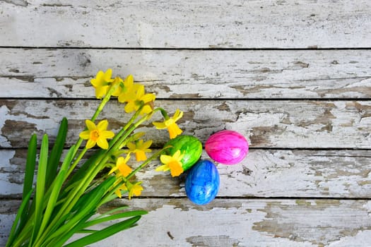 Easter bells and Easter eggs on old white wood background