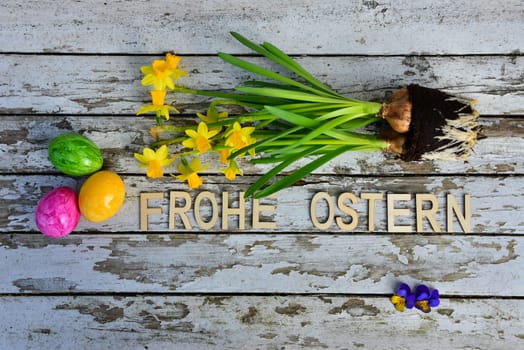 Easter bells and Easter eggs on old white wood background