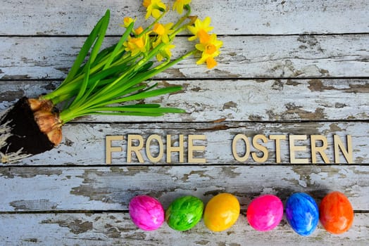 Easter bells and Easter eggs on old white wood background
