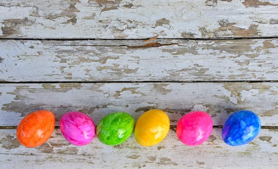 Easter bells and Easter eggs on old white wood background