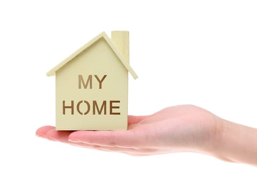 Miniature model of house on the hand isolated on white background