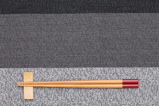 Chopsticks and chopsticks rest on table background