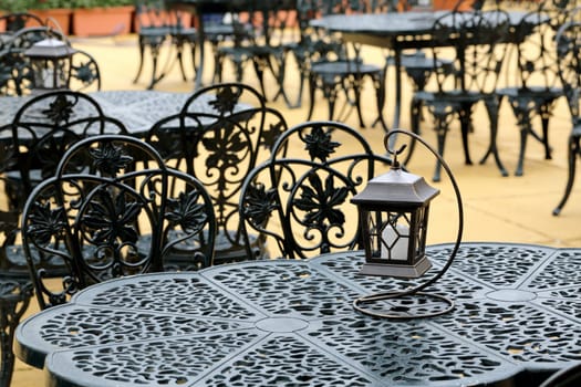 chairs and table with old lantern